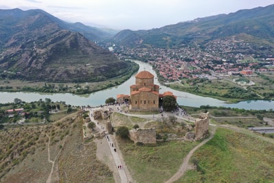 An aerial view brown concrete building near water during the day

